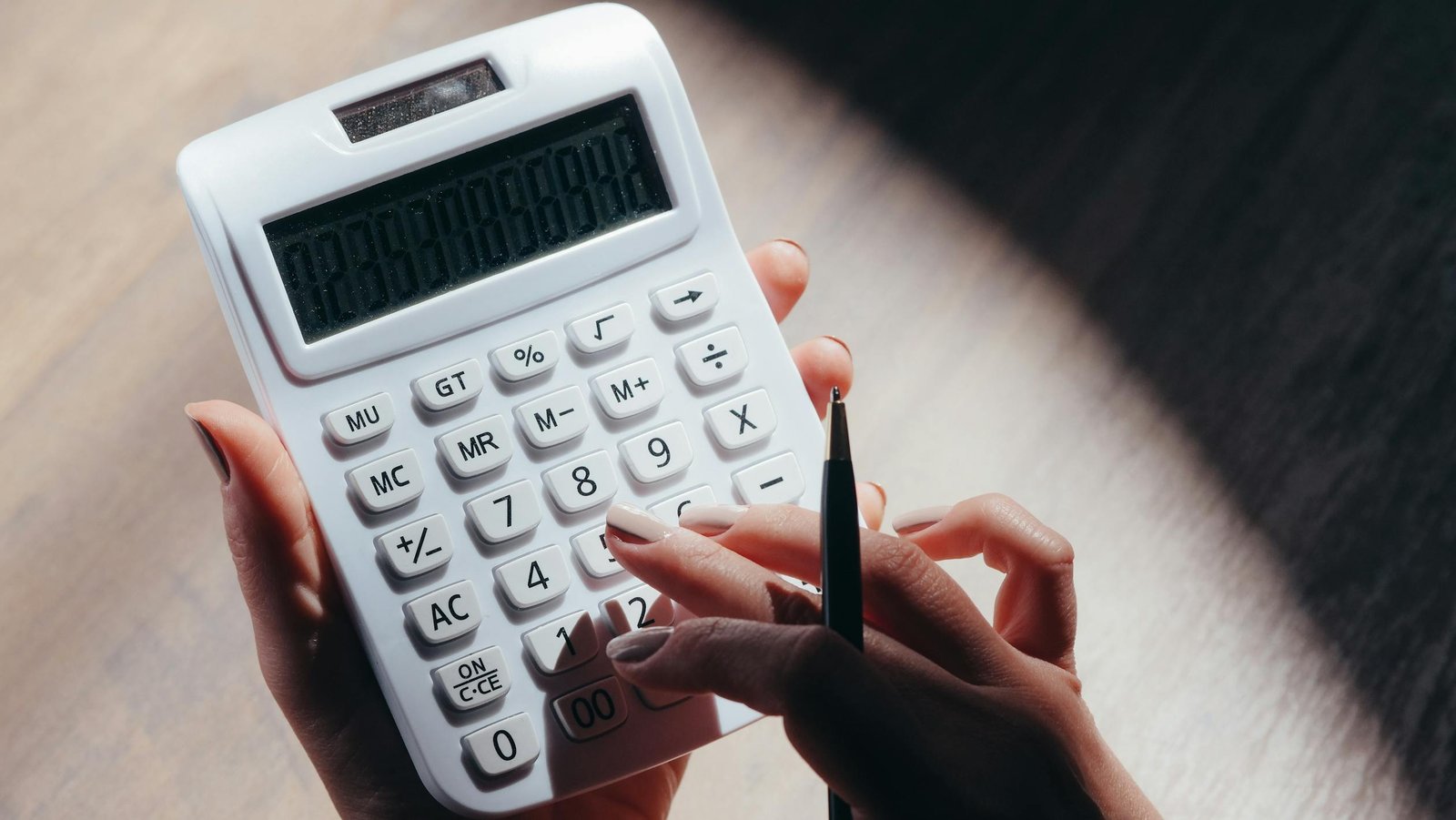 Person using calculator for budgeting