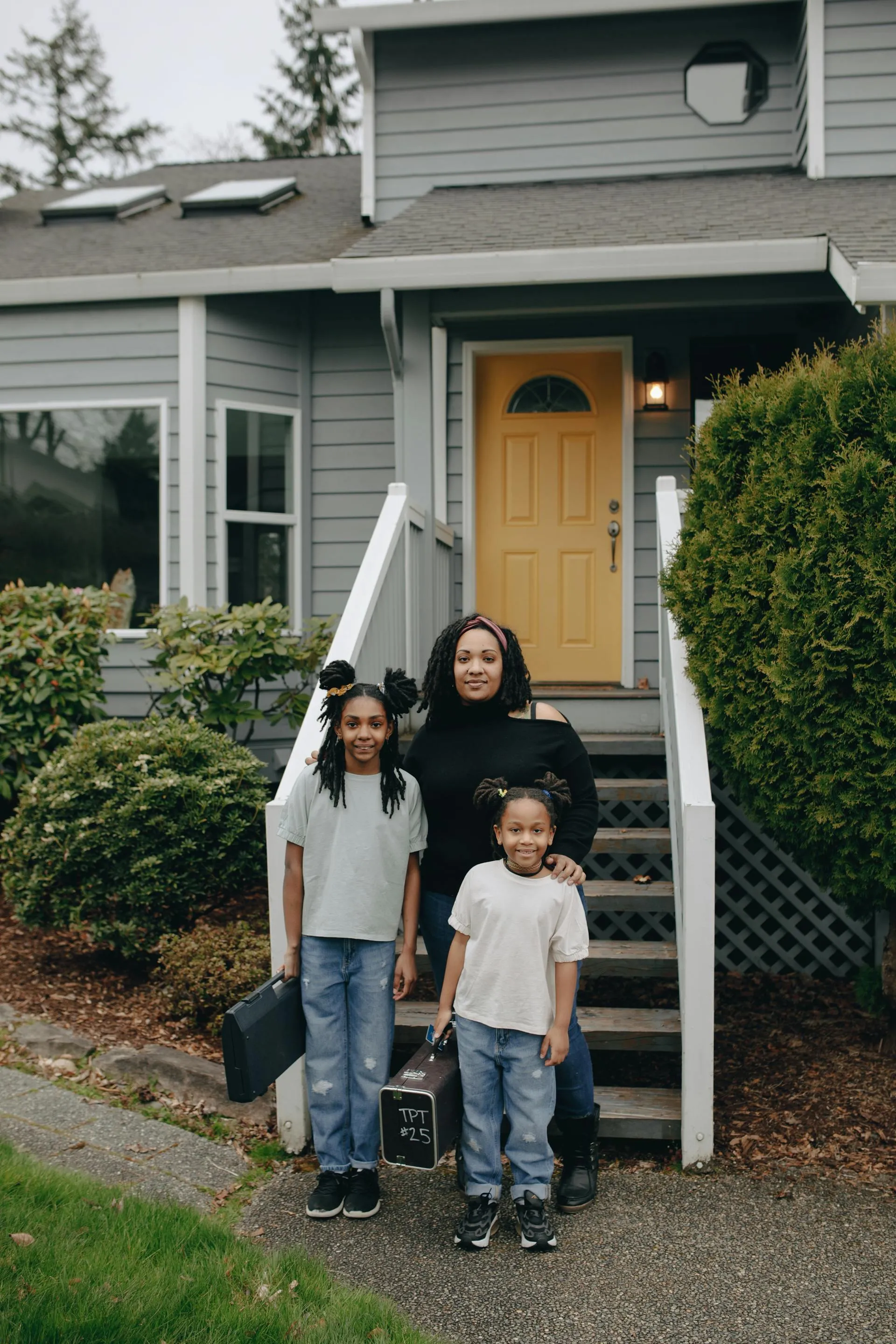 Family standing in front of their home in Glenmore