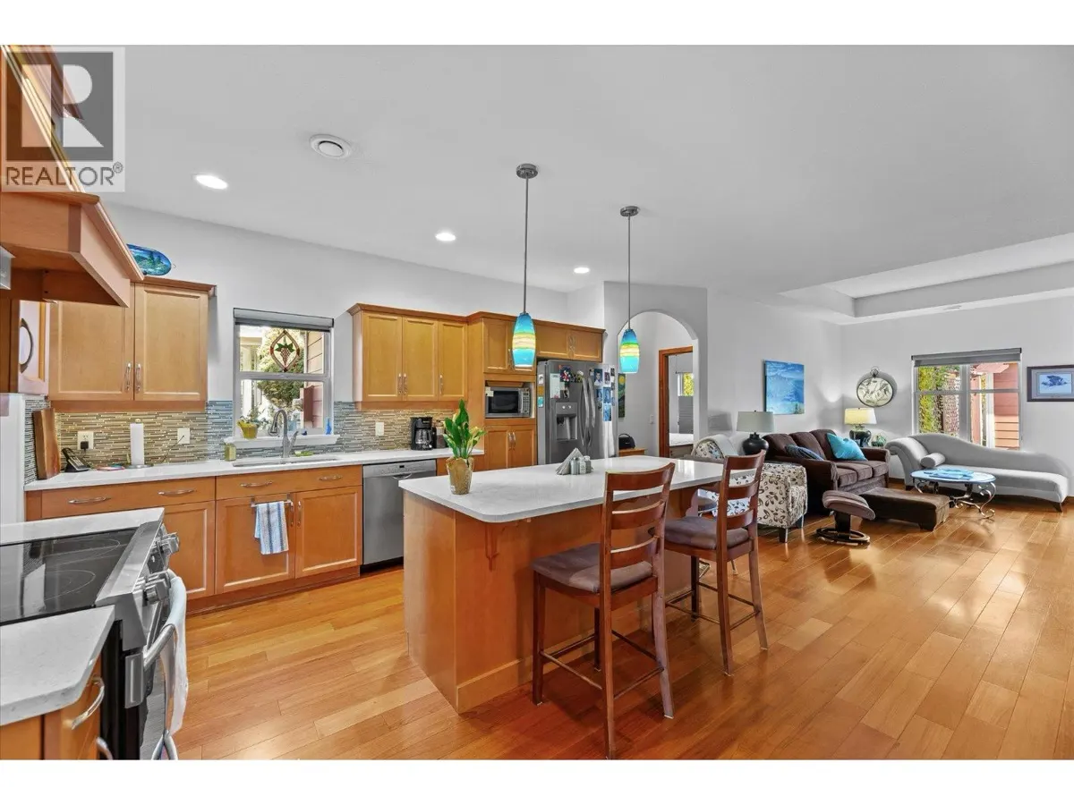 5323 Ptarmigan Street open concept kitchen and living area with hardwood floors and island