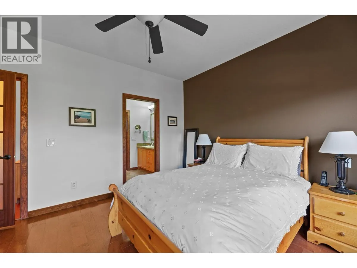 5323 Ptarmigan Street primary bedroom with ensuite access and ceiling fan