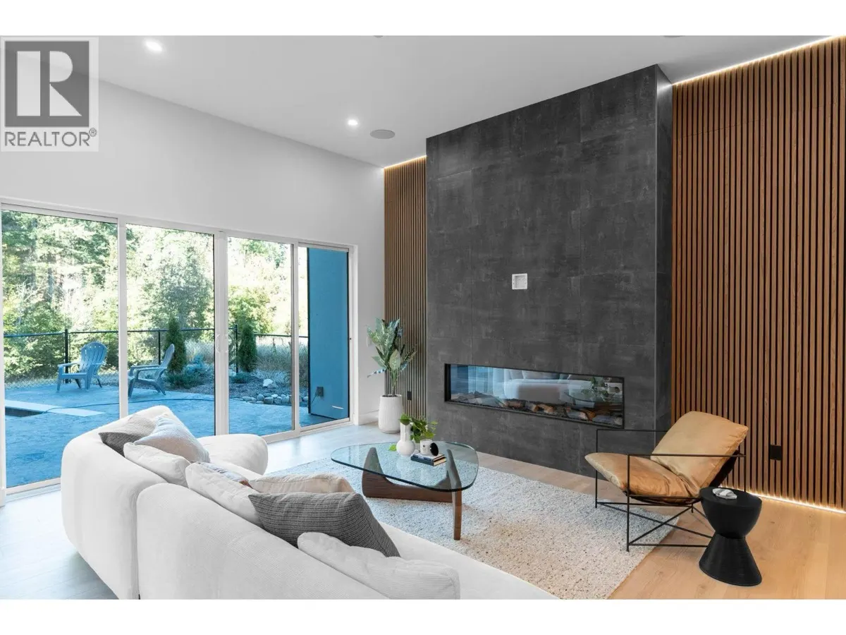 4630 McClure Road living room with dramatic dark tile fireplace and wood slat accent wall