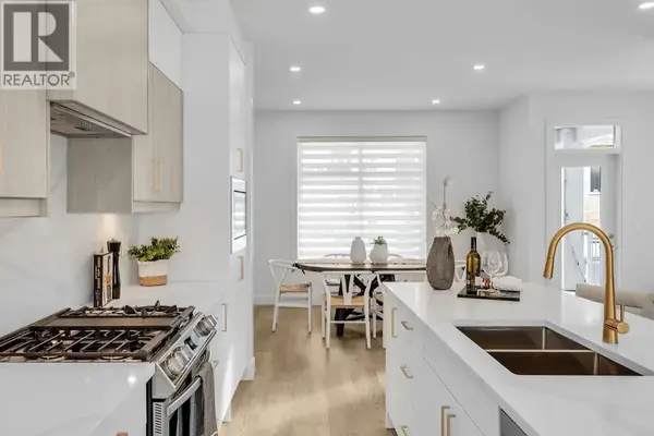 Parallel 4 townhome kitchen and dining area with gas range and gold fixtures