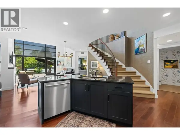 600 Sarsons Road Unit 205 open concept kitchen and living with curved staircase