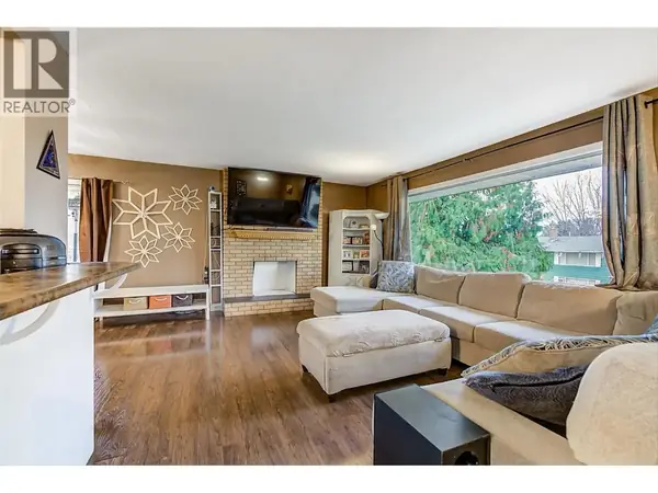 964 Tronson Drive living room with brick fireplace and large picture window