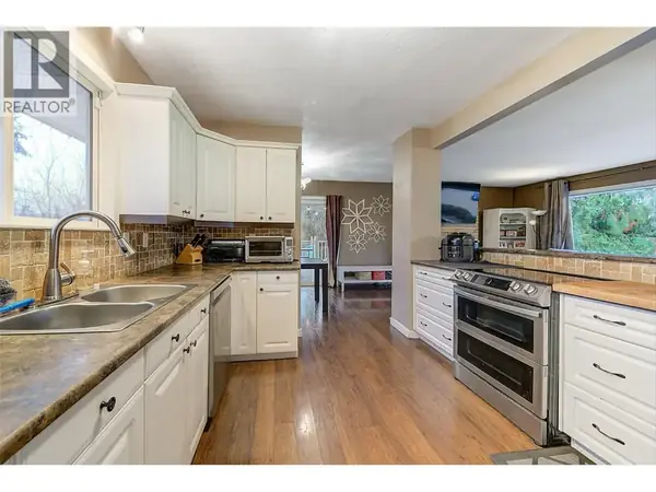 964 Tronson Drive kitchen with white cabinets and stainless steel appliances