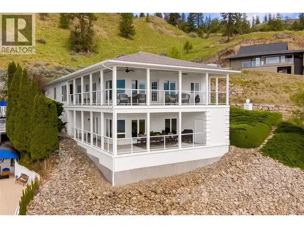 647 Royal Pine Drive exterior showing modern white home with wrap-around decks on hillside