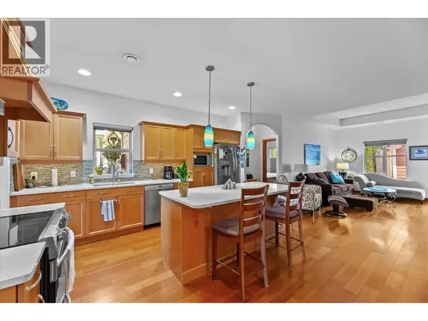 5323 Ptarmigan Street open concept kitchen and living area with hardwood floors and island